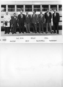 Men Standing by [Falconbridge] Bus